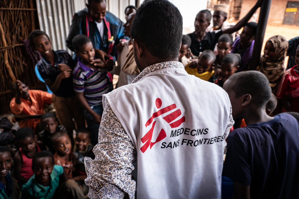 Ali Abdirahman Said, 25-year-old Health Education Supervisor.

Water purification health promotion and hand washing sessions in Qorile village, 72 km from Wardher on rough off-roads, about a 2.5-hour drive.  MSF’s male (former MSF community health worker) and female (tea house owner) local contact, help bringing together the community after the rains stop to come for the MSF health education session, divided into men and boys, and women and girls.